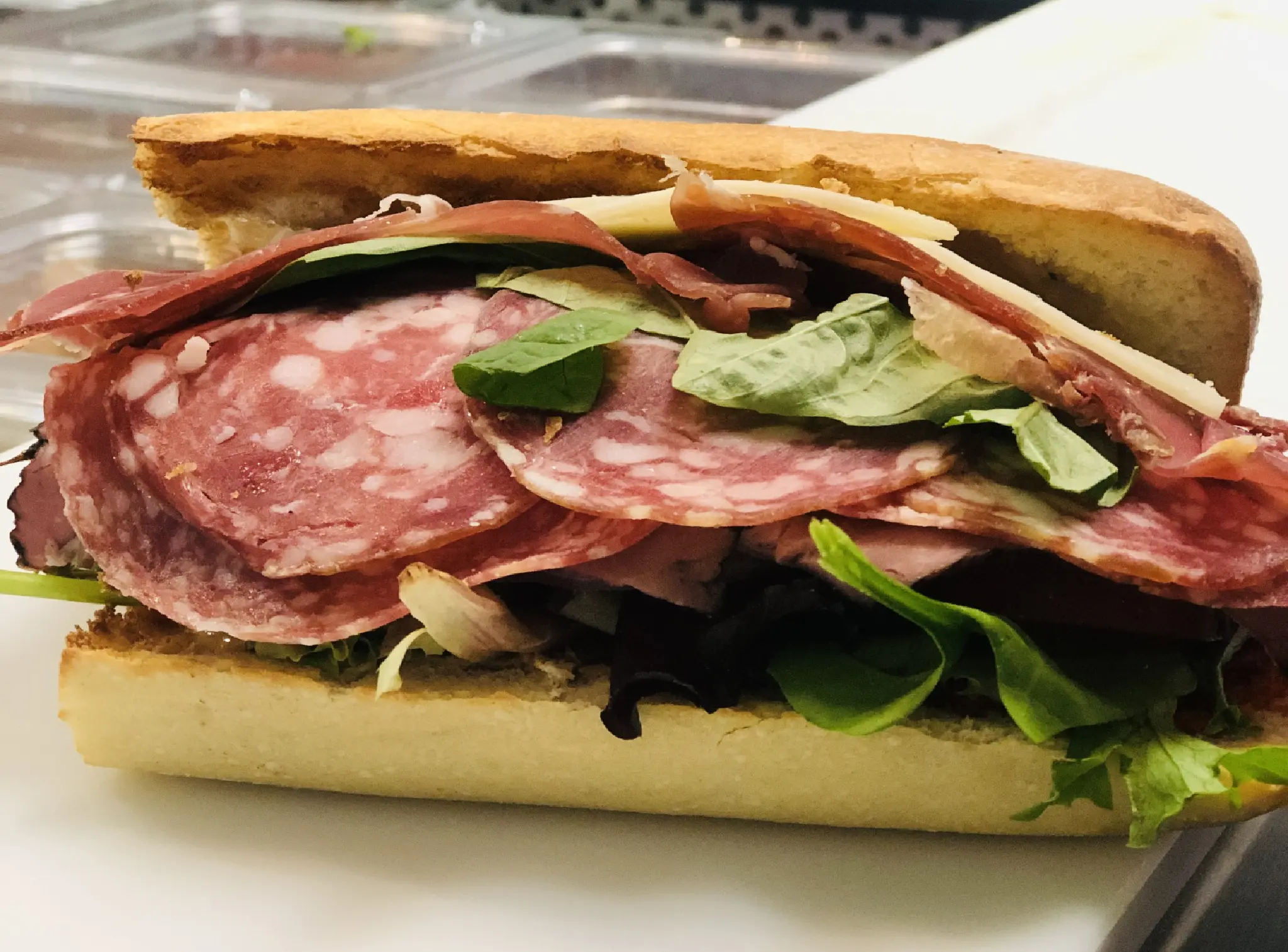 A sandwich with meat and vegetables on it.
