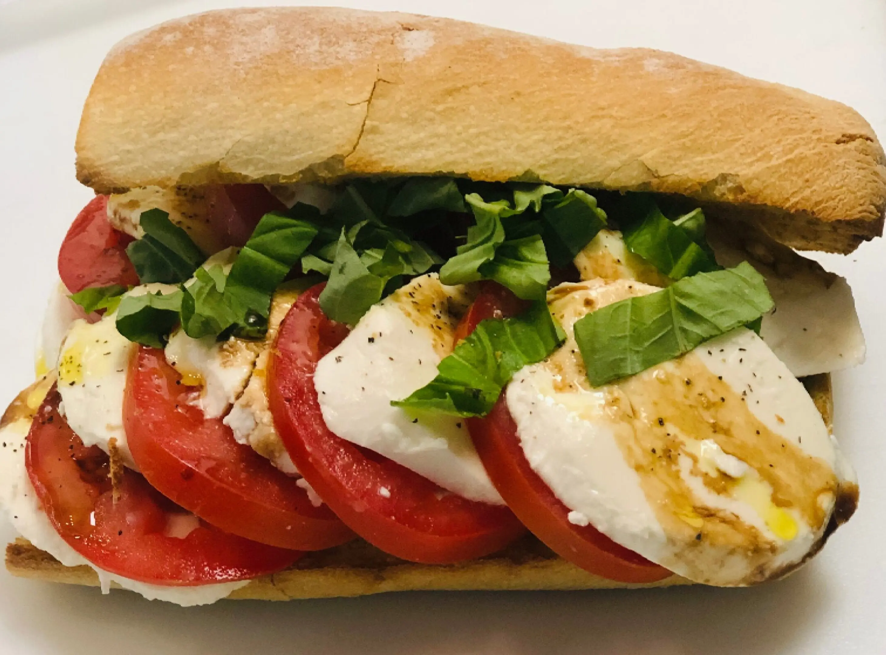 A sandwich with tomatoes and mozzarella on it.